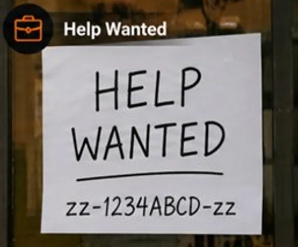 A handwritten HELP WANTED sign on a glass door with zz-1234ABCD-zz written below.